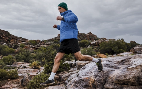 A man is jogging on top of hills